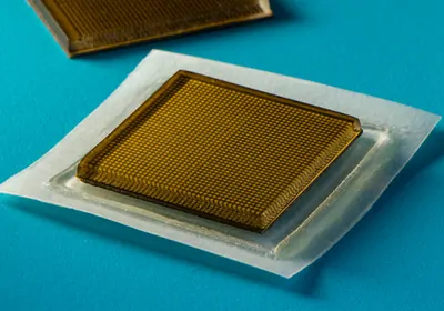 An adhesive patch designed by researchers at MIT on a blue background